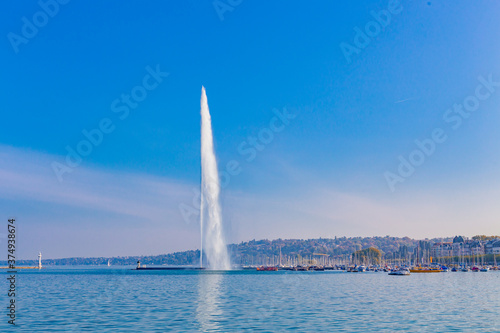 The lake Geneva in Switzerland, with the big water fountain in it, on a sunny day.