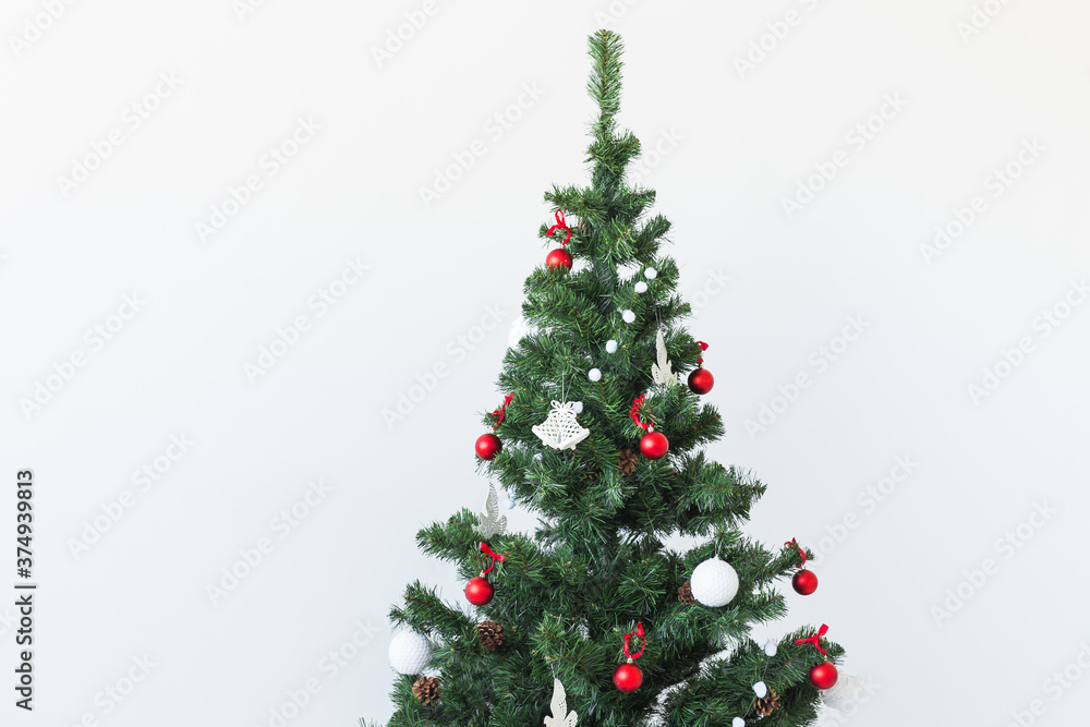 Holidays and celebration concept - Decorated Christmas tree on white background with copy space. Holidays and celebration concept - Decorated Christmas tree on white background with copy space.