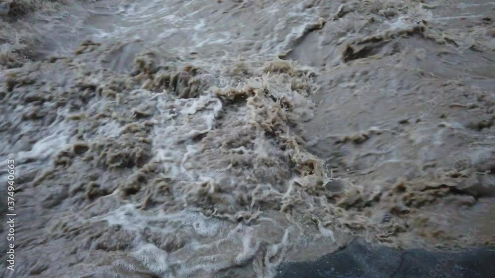 Dirty river with muddy water in flooding period during heavy rains Dirty river with muddy water in flooding period during heavy rains