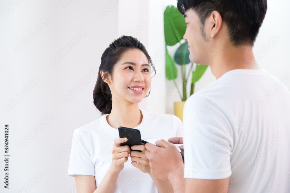 Happy teen couple using smart phones together. Close view of beautiful woman. Happy teen couple using smart phones together. Close view of beautiful woman.