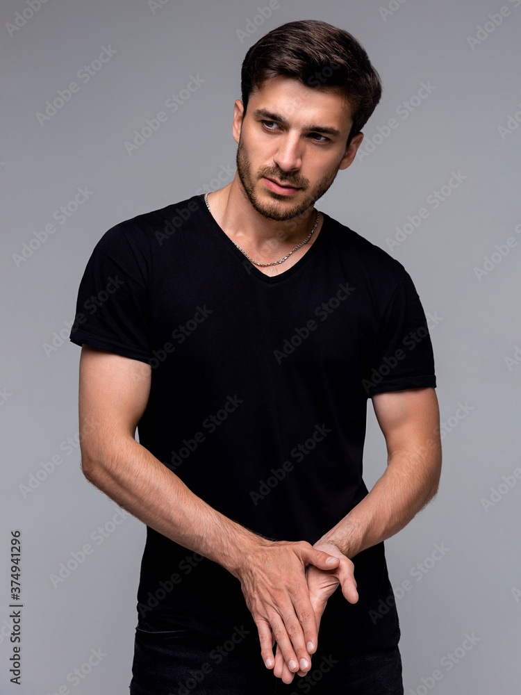 Hipster handsome male model with beard wearing black blank t-shirt with space for your logo or design in casual urban style Hipster handsome male model with beard wearing black blank t-shirt with space for your logo or design in casual urban style