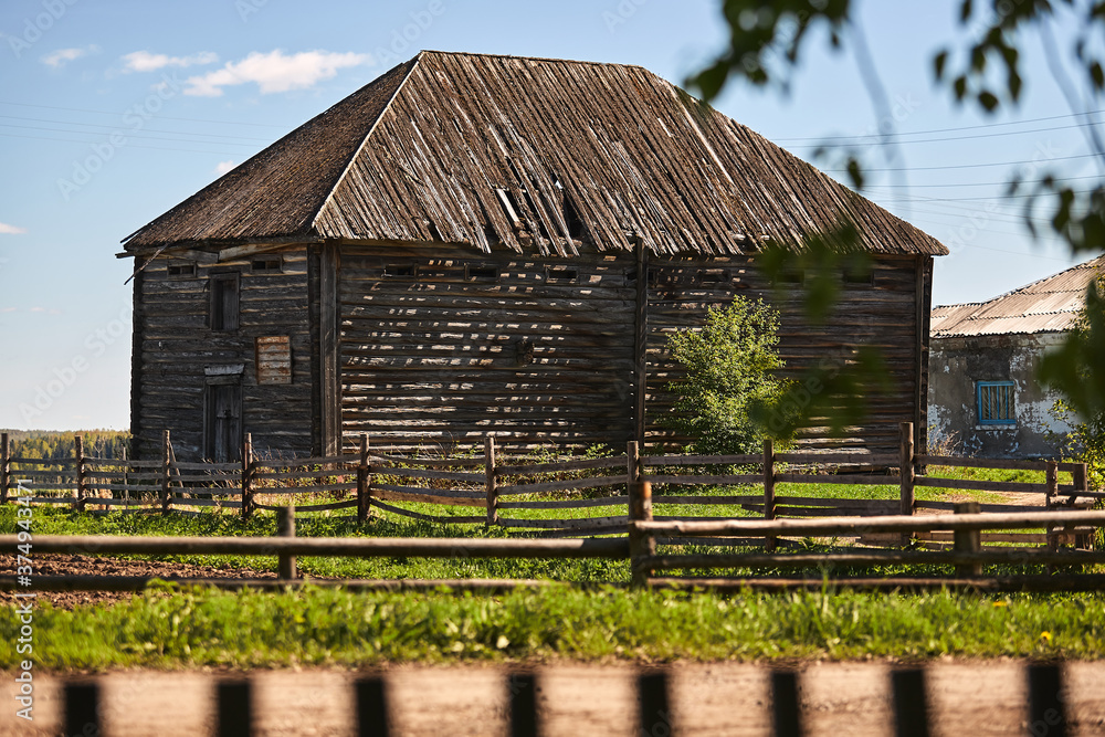 old wooden dilapidated houses in the village on a summer day old wooden dilapidated houses in the village on a summer day