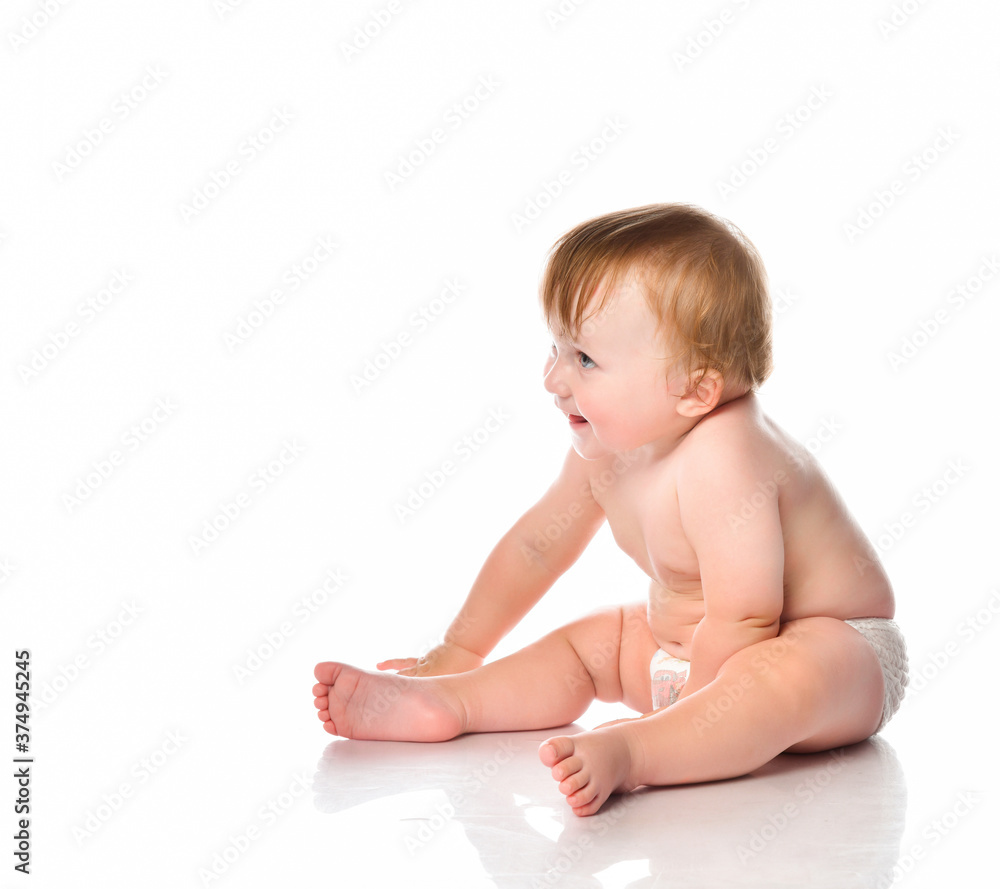 Funny baby boy sitting barefoot on a white background. Funny baby boy sitting barefoot on a white background.