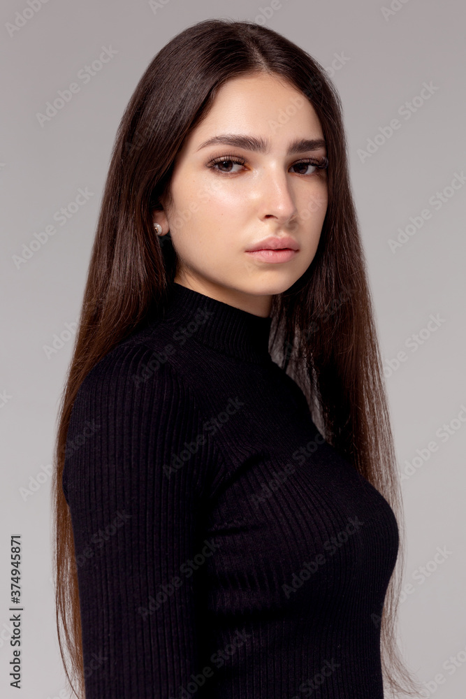 Portrait of beautiful brunette woman in black dress. Fashion photo Portrait of beautiful brunette woman in black dress. Fashion photo