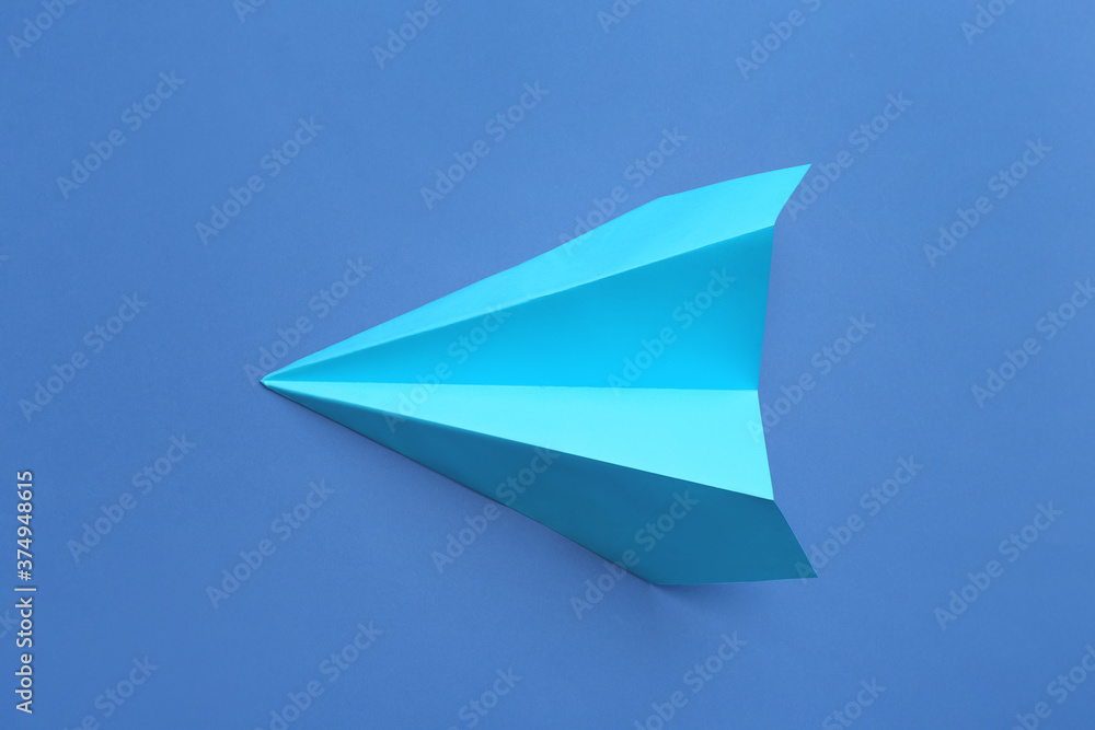 Paper plane on blue background, top view Paper plane on blue background, top view
