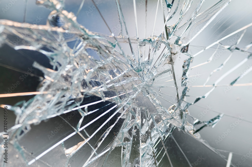 Accident - close-up of broken window. Detail of rifts of cracked glass.