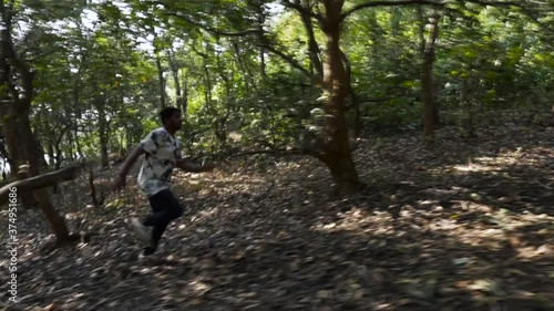 Man running in the woods of Jambughoda, Gujarat photo