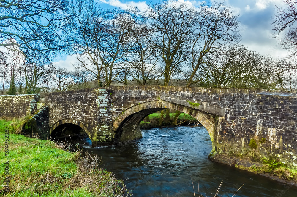 A view across River Syfynwy, Wales towards the Gelli bridge, an eighteenth-century, grade 2 listed bridge, bridge
