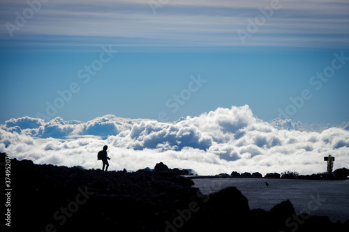 The silhouette of a photographer at the top of Haleakala National Park in Maui, Hawaii.
