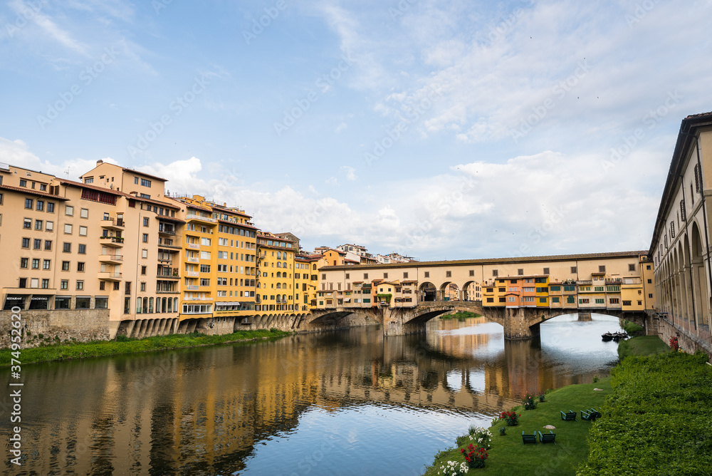 FLORENCE / ITALY - MAY 6 2017: Ponte Vecchio and its surroundings reflected in the Arno river.