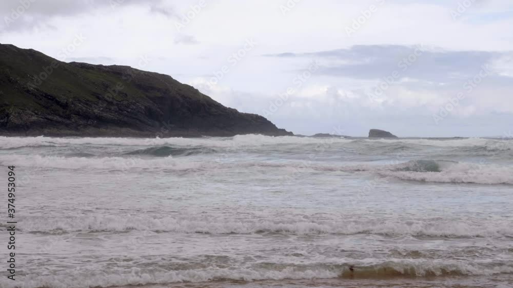 Rolling Waves From Cave Beach Island In Donegal, Ireland. - slow panning left Rolling Waves From Cave Beach Island In Donegal, Ireland. - slow panning left