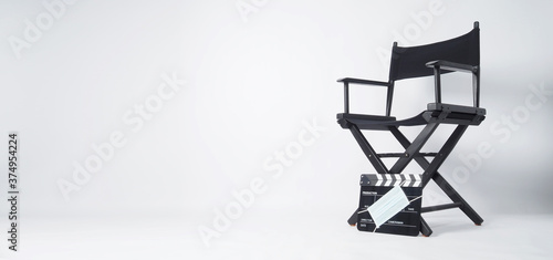 Director chair and black Clapper board or movie slate with face mask. it use in video production and cinema industry on white background.