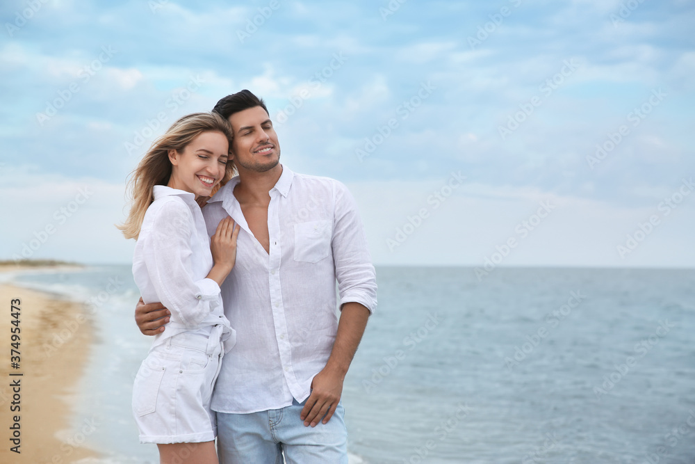 Happy couple on beach, space for text. Romantic walk
