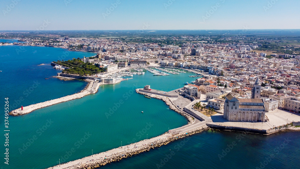 Aerial view of Trani in the southeastern region of Apulia in Italy - Entrance to the old port of Trani from above with the Cathedral of San Nicola Pellegrino on the coast of the Adriatic Sea