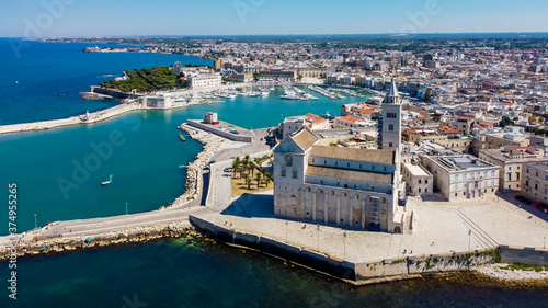 Aerial view of Trani in the southeastern region of Apulia in Italy - Entrance to the old port of Trani from above with the Cathedral of San Nicola Pellegrino on the coast of the Adriatic Sea
