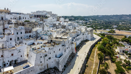 Wallpaper Mural Aerial view of Ostuni "The White City" in Apulia, southern Italy - White houses in the old town built on a slope over the olive trees Torontodigital.ca