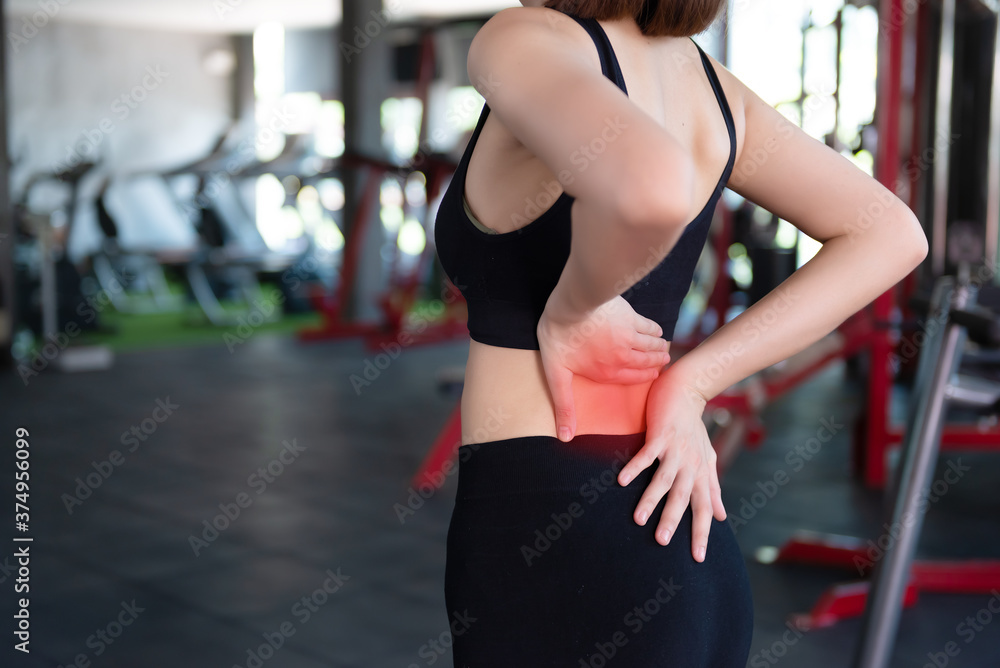 Asian slim woman play fitness at the gym,She pain from exercise Asian slim woman play fitness at the gym,She pain from exercise