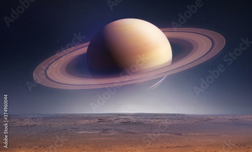 Landscape with saturn planet in sky with stars. Fantasy space wallpaper with planet over the land. Sci-fi. Elements of this image furnished by NASA photo