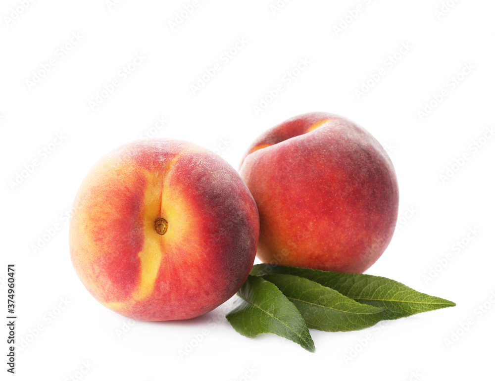 Delicious ripe juicy peaches with leaves isolated on white Delicious ripe juicy peaches with leaves isolated on white