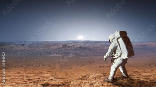 Astronaut on surface of red planet Mars. Martian colonizer. Spaceman. Expedition to Mars. Elements of this image furnished by NASA.