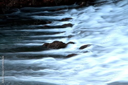 River cascade, waterfall with black rocks