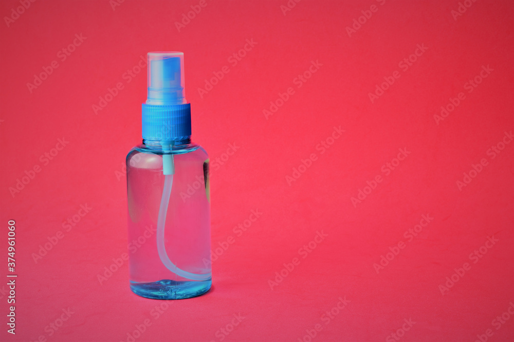 Close up, hygienic measures, hydroalcoholic gel, on a red background, space for text Close up, hygienic measures, hydroalcoholic gel, on a red background, space for text
