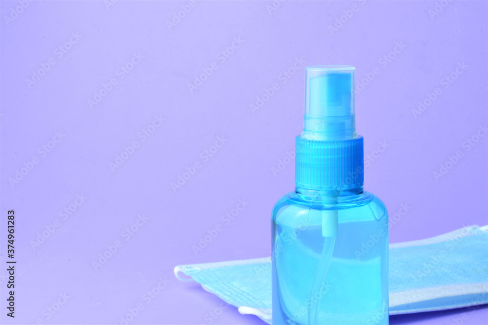 Close up, hygienic measures, hydroalcoholic gel and surgical masks, on a blue background Close up, hygienic measures, hydroalcoholic gel and surgical masks, on a blue background