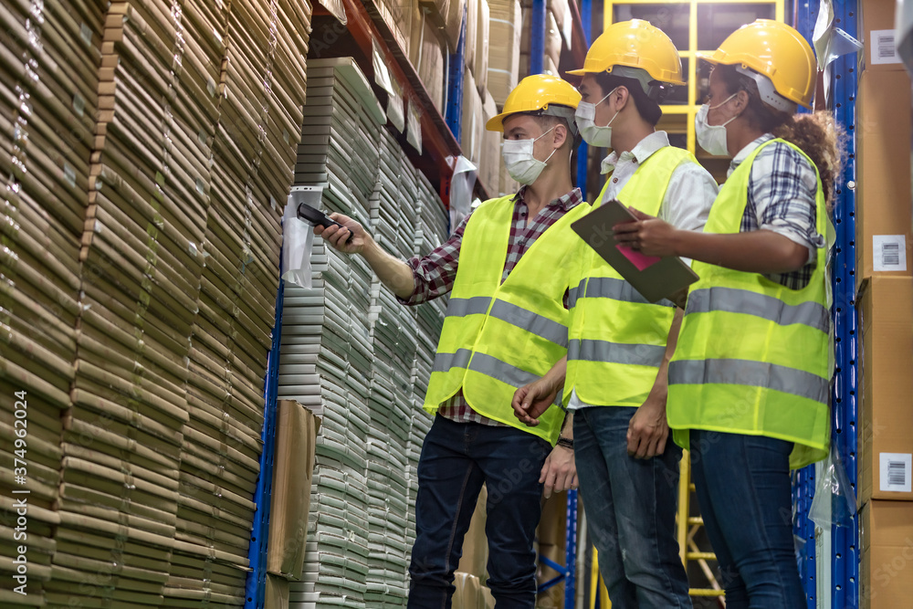 Interracial warehouse workers team do inventory. Interracial warehouse workers team do inventory.