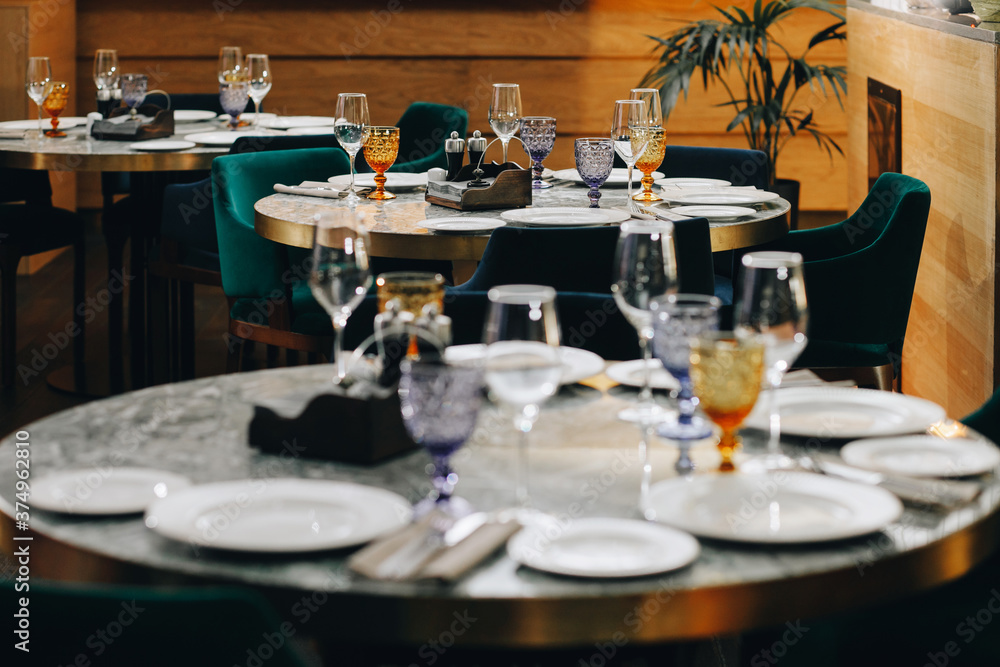 tableware Glasses, flower fork, knife served for dinner in restaurant with cozy interior tableware Glasses, flower fork, knife served for dinner in restaurant with cozy interior