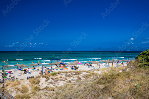 Fototapeta Naklejka Na Ścianę i Meble -  PLAYA DE MURO, Mallorca, Spain - 23 July 2020 - People enjoying hot summer day on popular city beach in Mallorca.