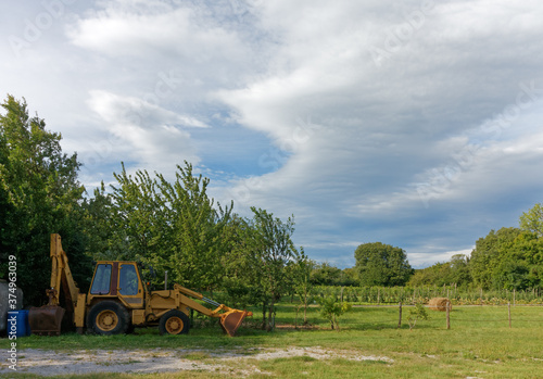 Yellow Tractor Parked in an Agricultural Area