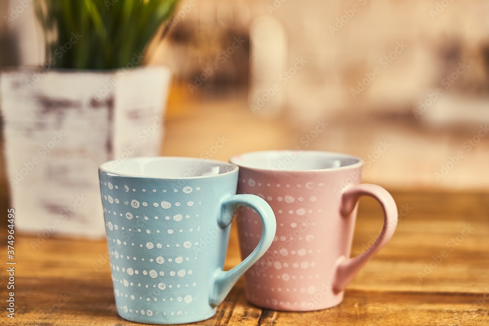 Two coffee cups on wooden table in the kitchen. Copy space. Two coffee cups on wooden table in the kitchen. Copy space.