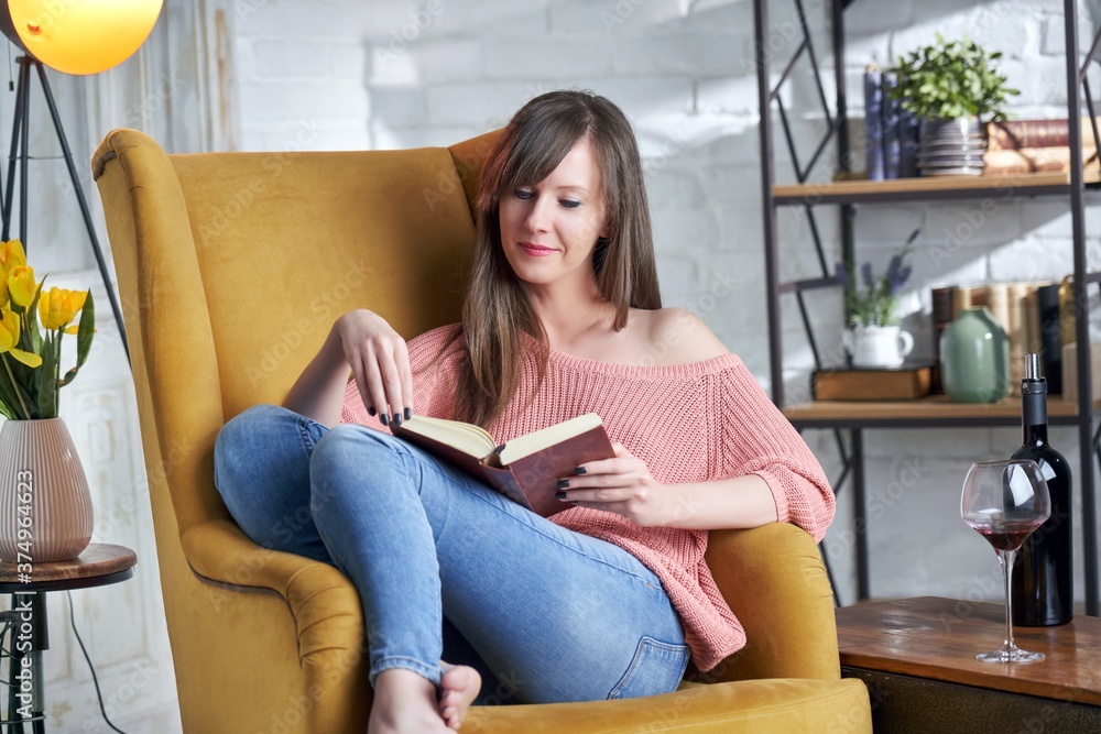 Portrait happy smiling woman reading book at home. Portrait happy smiling woman reading book at home.