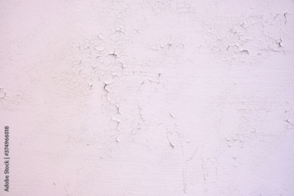 Cracked new paint on a white wall, background of fresh paint close-up Cracked new paint on a white wall, background of fresh paint close-up