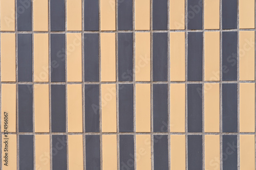 Rows of beige and black tiles, background