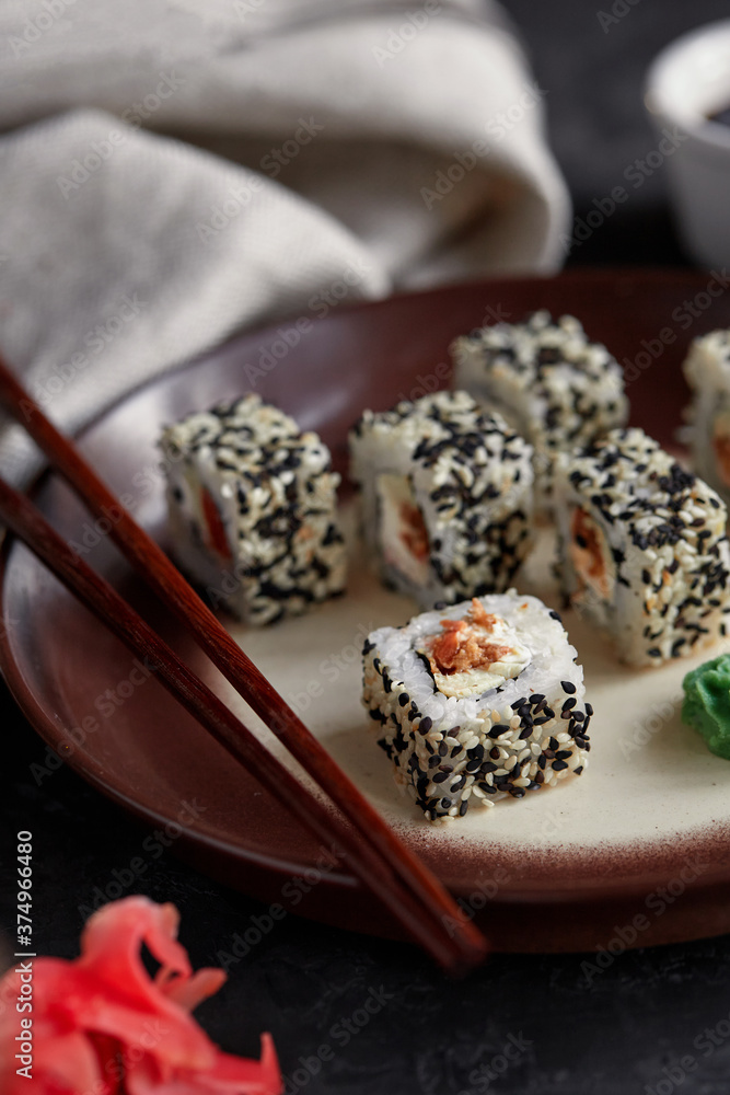 Japanese cuisine, fresh sushi on a light background. Assorted sushi with wasabi, soy sauce and ginger Japanese cuisine, fresh sushi on a light background. Assorted sushi with wasabi, soy sauce and ginger