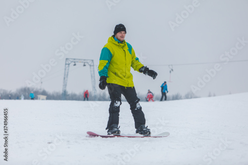 man snowboarding down by hill