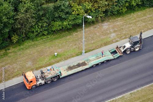 Loading an excavator onto a truck trailer for transporting construction equipment