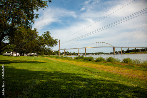 Wide angle view of the Chesapeake and Delaware Canal (C and D canal) at the Back Creek section in Chesapeake City, MD. An old metal arched bridge is on the canal.