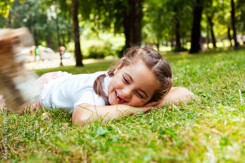 little cute caucasian girl playing cheerful in green park at summer, lifestyle people concept