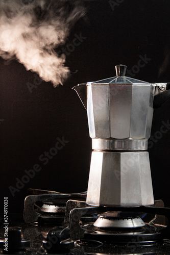 Steaming Moka Pot on a gas stove photo