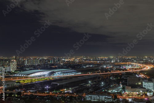 Bangkok, thailand - Aug 28, 2020 : Aerial view of Bang Sue central station with skyscrapers background at night. Selective focus. © num