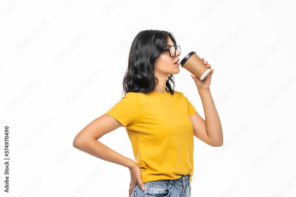 Young beautiful woman offers white cup of coffee on gray background Young beautiful woman offers white cup of coffee on gray background