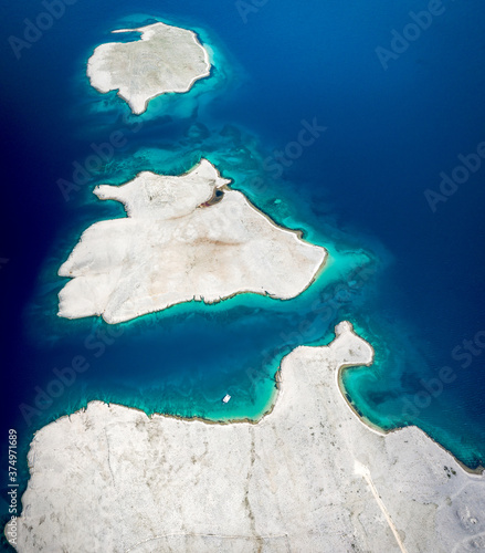 Aerial view of islands surrounded by turquoise water in Vlasici, Pag, Croatia