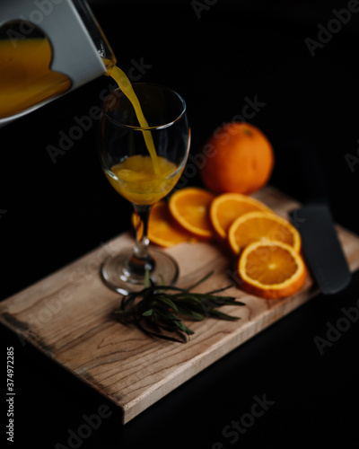 cup with orange juice on little table