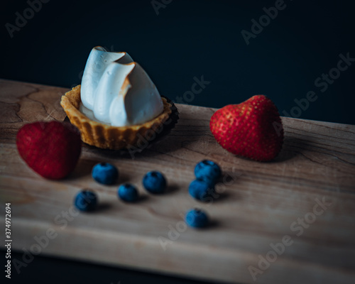 lemon pie strawberries and blueberries in table