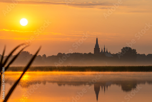 Foggy sunrise over the village of Popowo