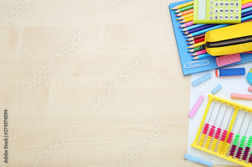 Different school supplies on brown wooden table