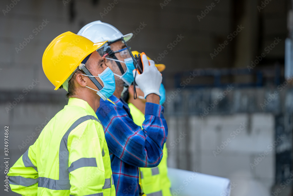 Group civil engineer wearing protective face mask during the inspection in construction site,Coronavirus has turned into a global emergency. Group civil engineer wearing protective face mask during the inspection in construction site,Coronavirus has turned into a global emergency.