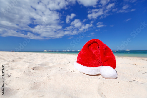 Christmas santa hat on sandy caribbean beach